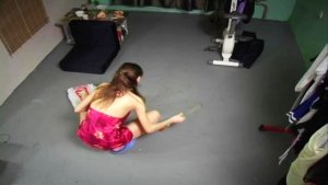 Leggy doll in nightie sweeping the floor