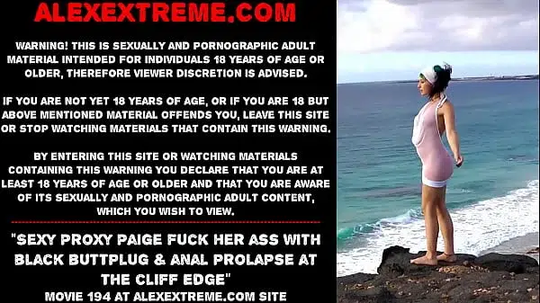 Sexy Proxy Paige fuck her ass with black buttplug & anal prolapse at the cliff edge