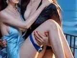 Long dark-haired lovers kissing intimately on moonlit ocean